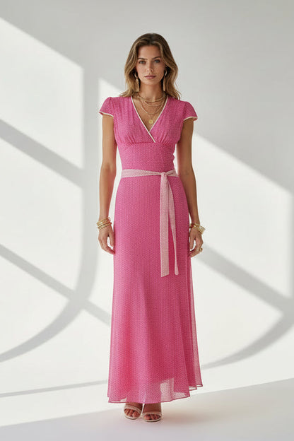 Woman wearing a pink dress with a white background