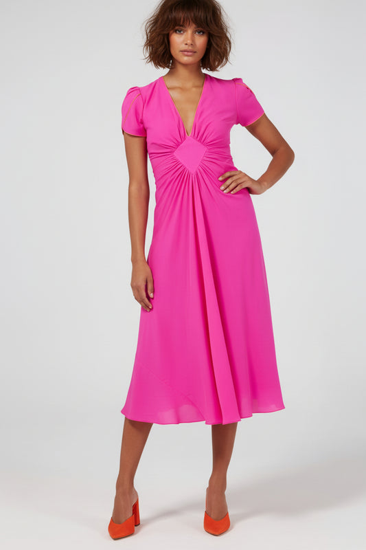 Woman wearing a bright pink dress on a white background