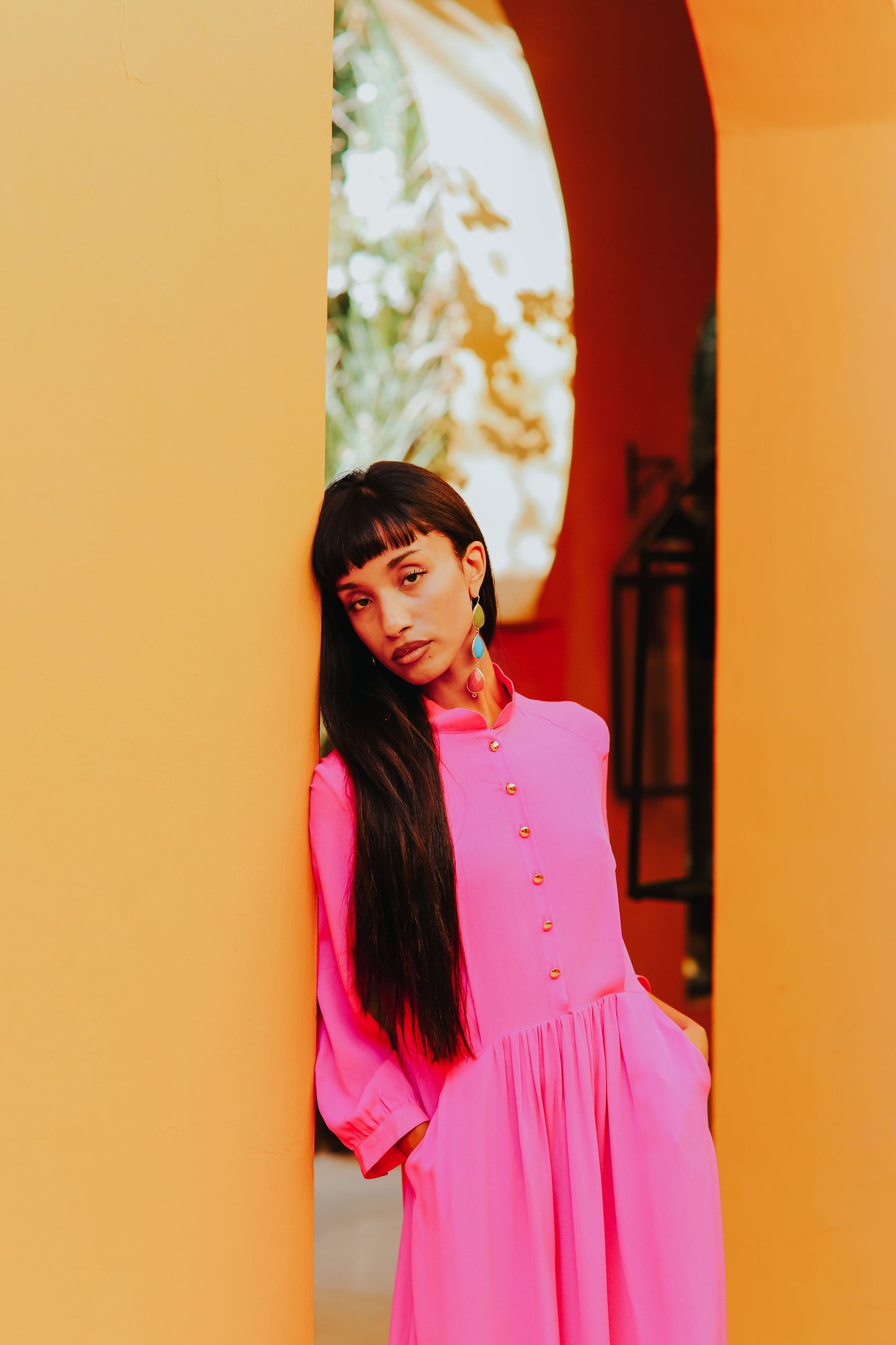 Detail of standing collar and enamel button front on silk dress