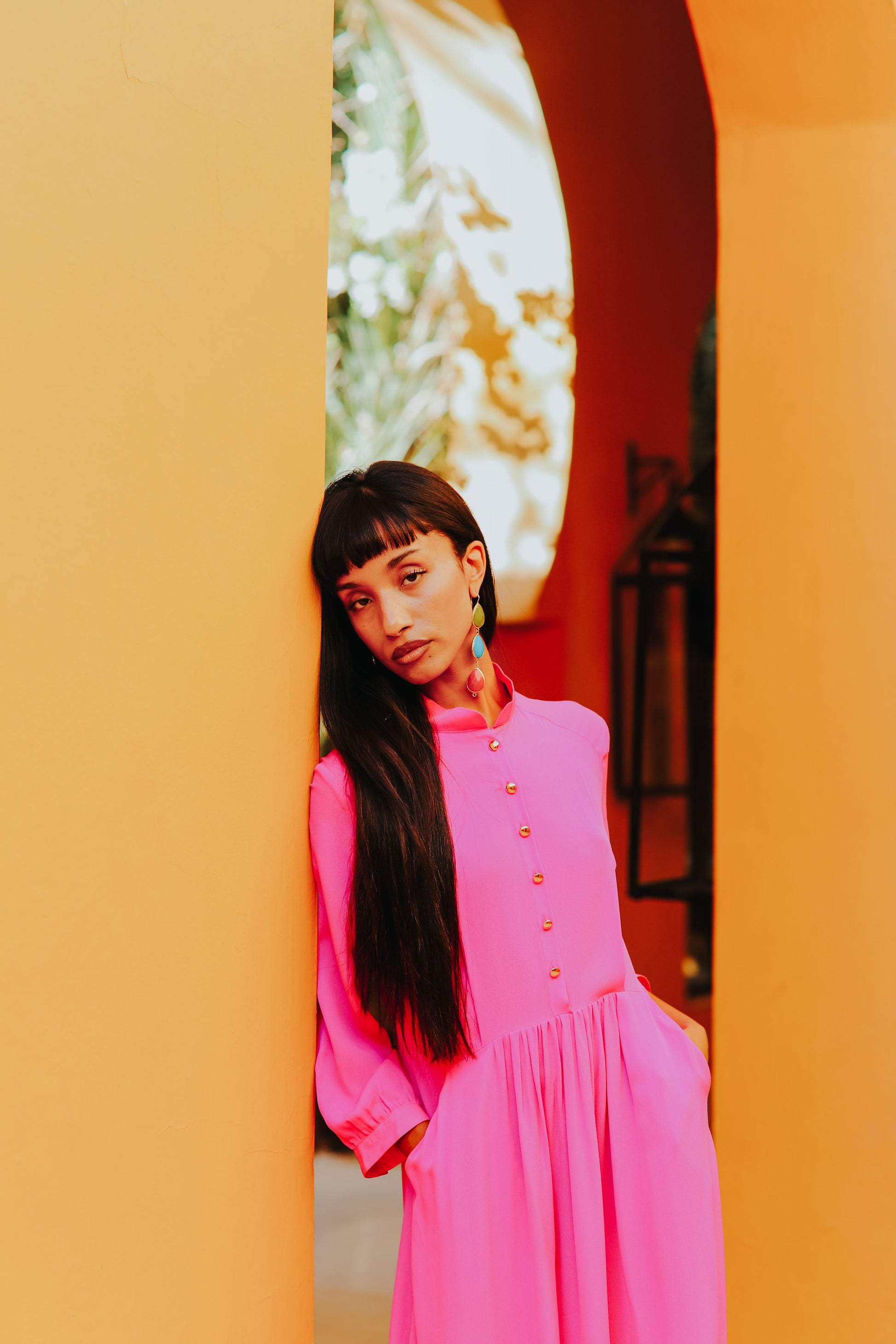 Detail of standing collar and enamel button front on silk dress