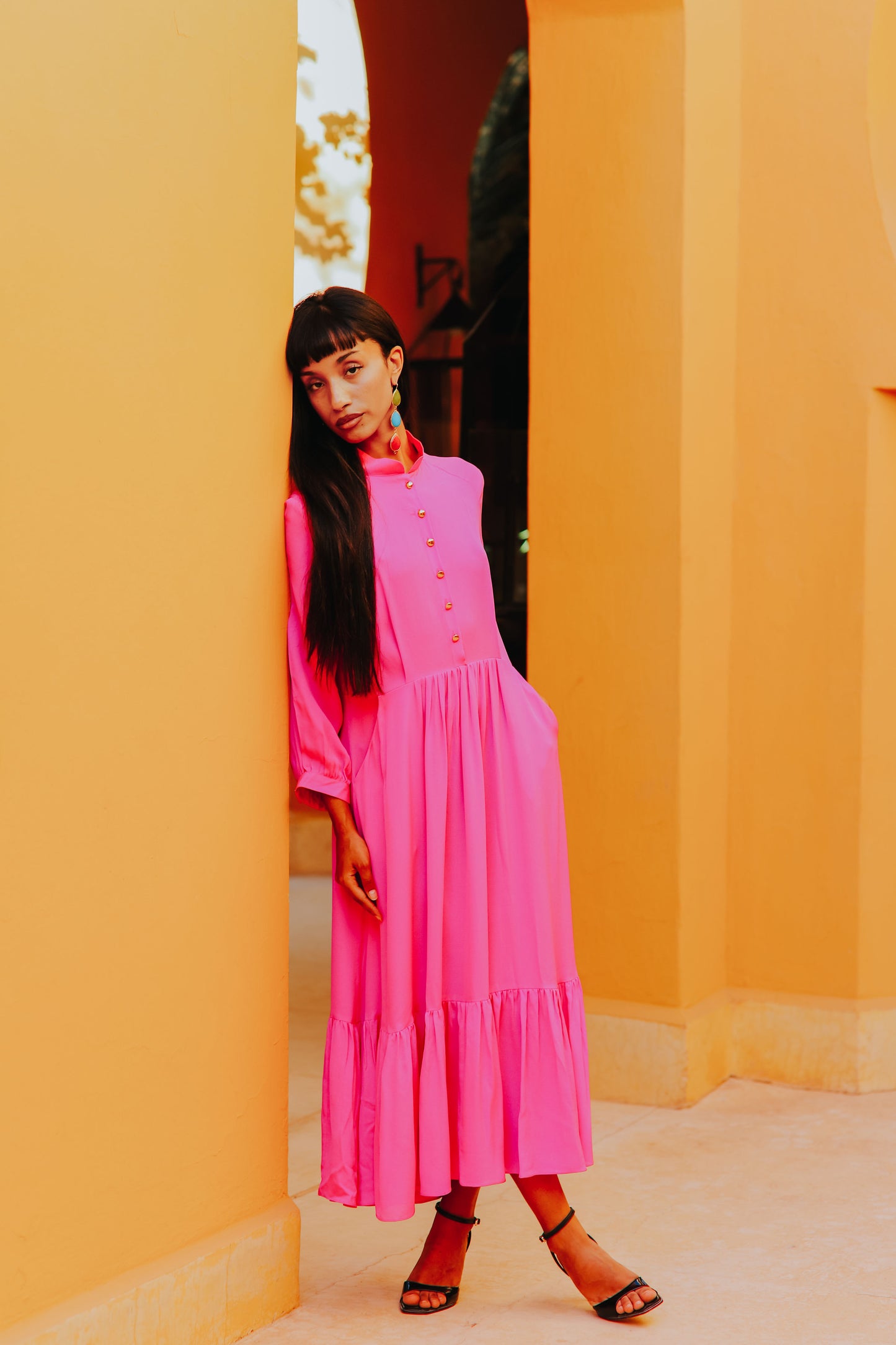 Bright pink designer dress styled for elegant occasion wear