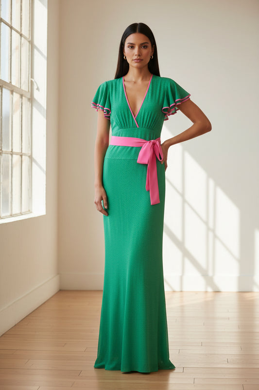 A green maxi dress with a bright pink waist tie and pink trim details, shown against a plain white background.