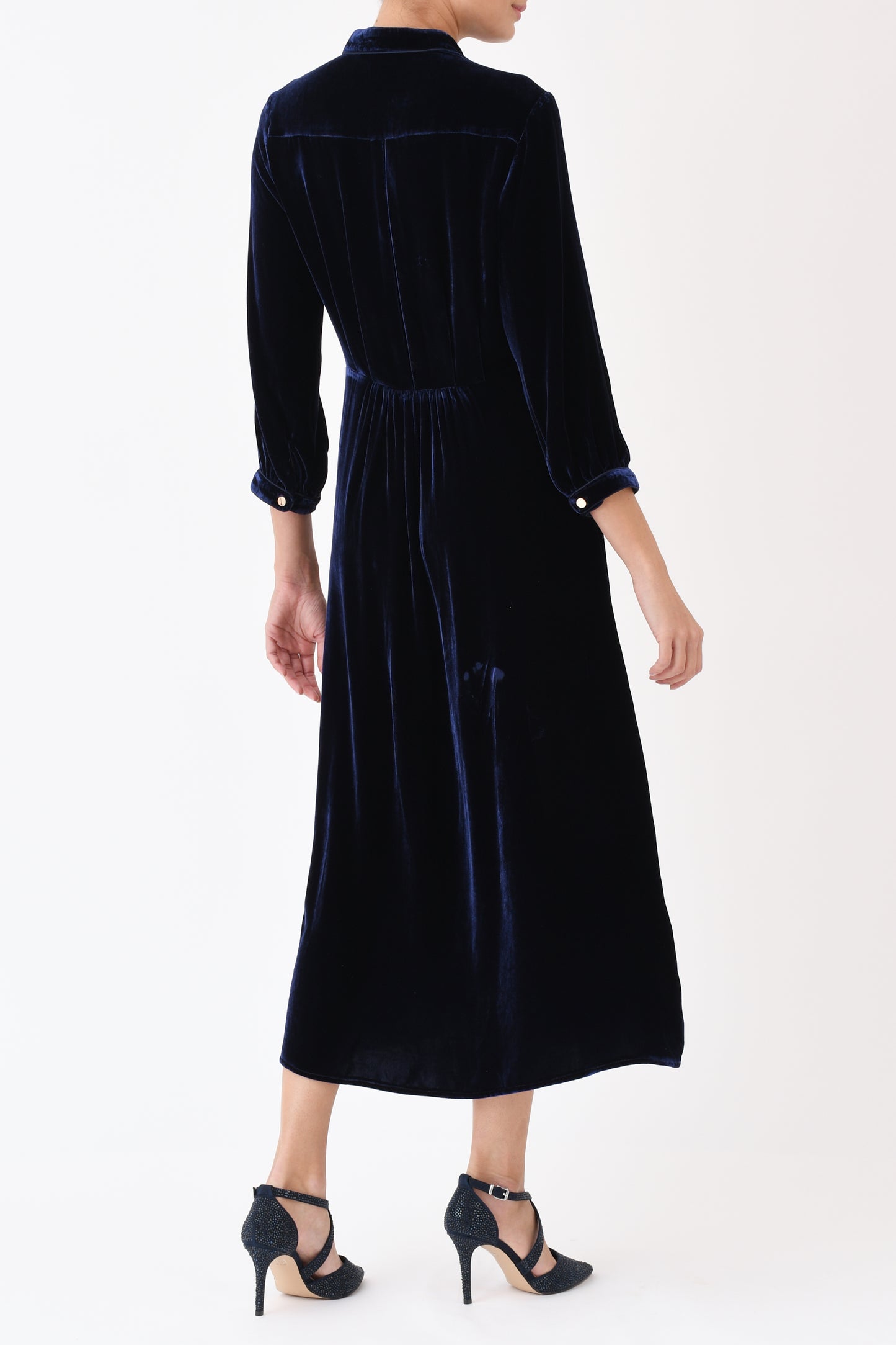 Navy velvet Anastasia dress side view showing flattering silhouette