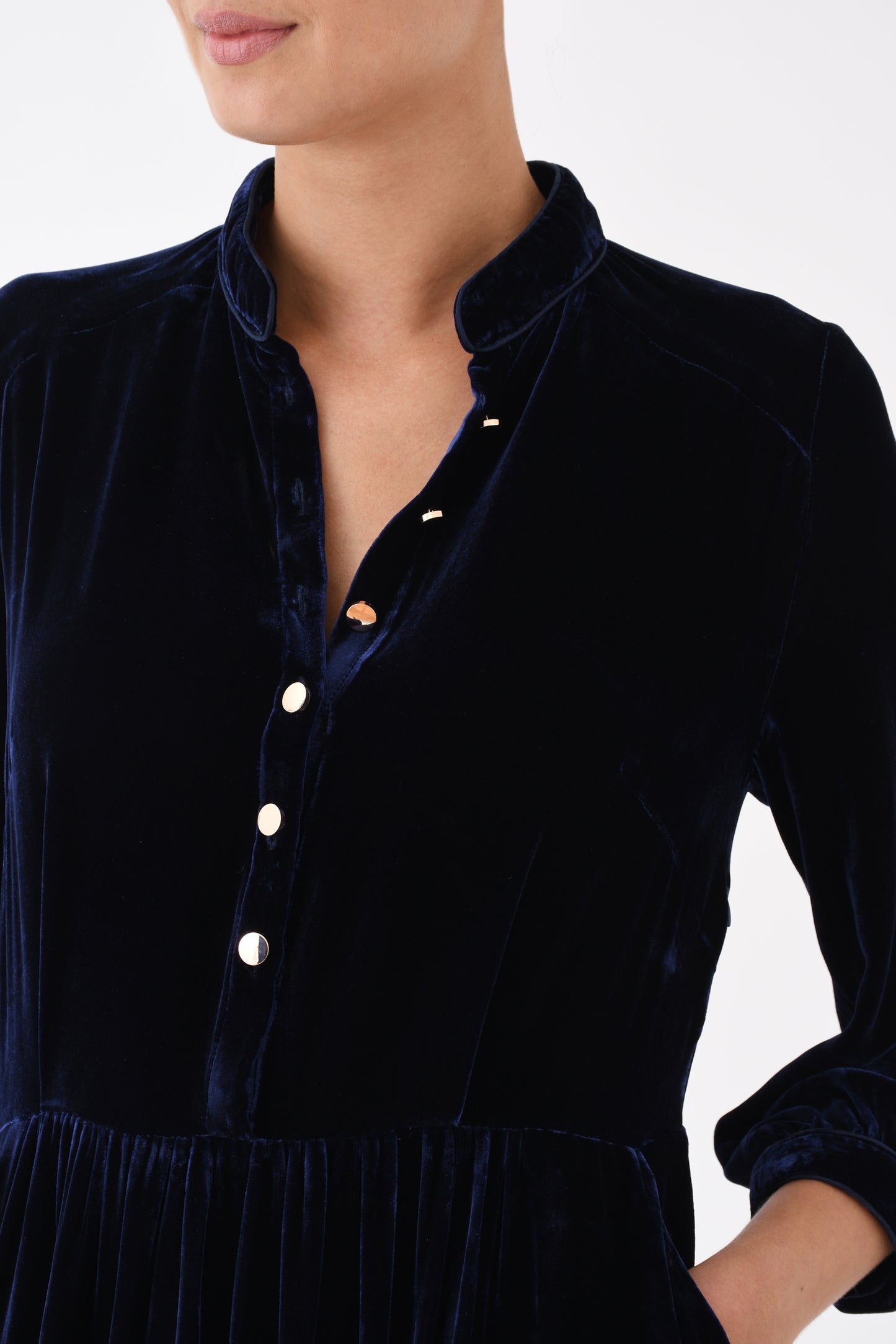 Close-up of navy velvet dress button-front bodice and waist detail