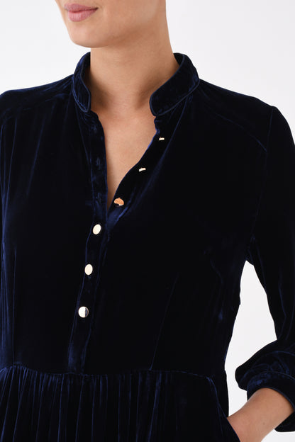 Close-up of navy velvet dress button-front bodice and waist detail