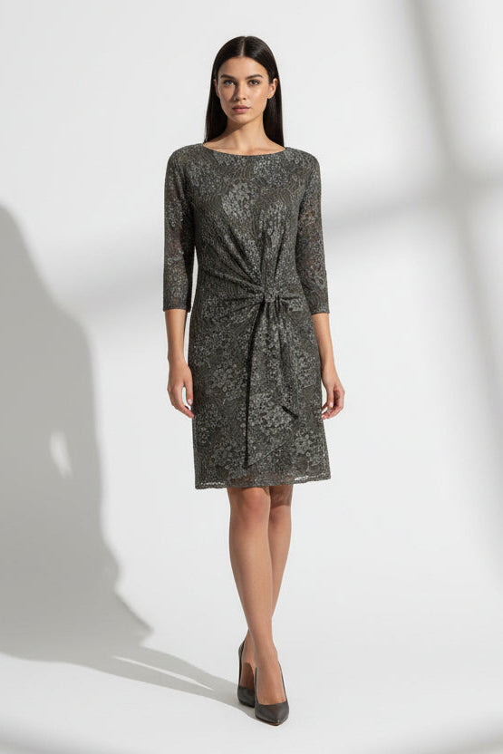 Dark floral lace dress with a knot detail on a white background